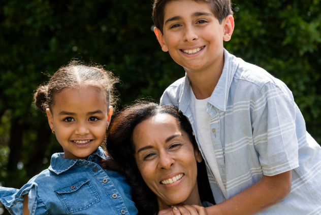 Mother and her two young children smiling